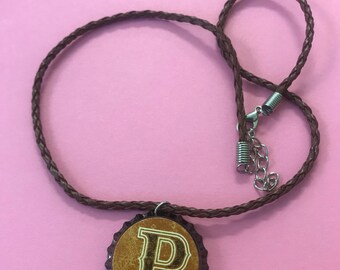Bottlecap necklace mongrammed with the letter P.