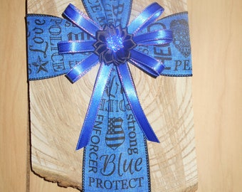 Ribbon cross on wood plague.