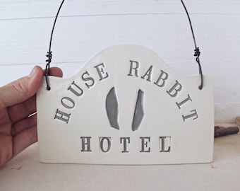House Rabbit Hotel. Hand-Built Ceramic Wall Sign. Rustic Folk Art For Rescued House Rabbits. With Gray Letters and Ears.