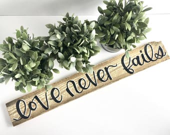 Love Never Fails Wood Sign