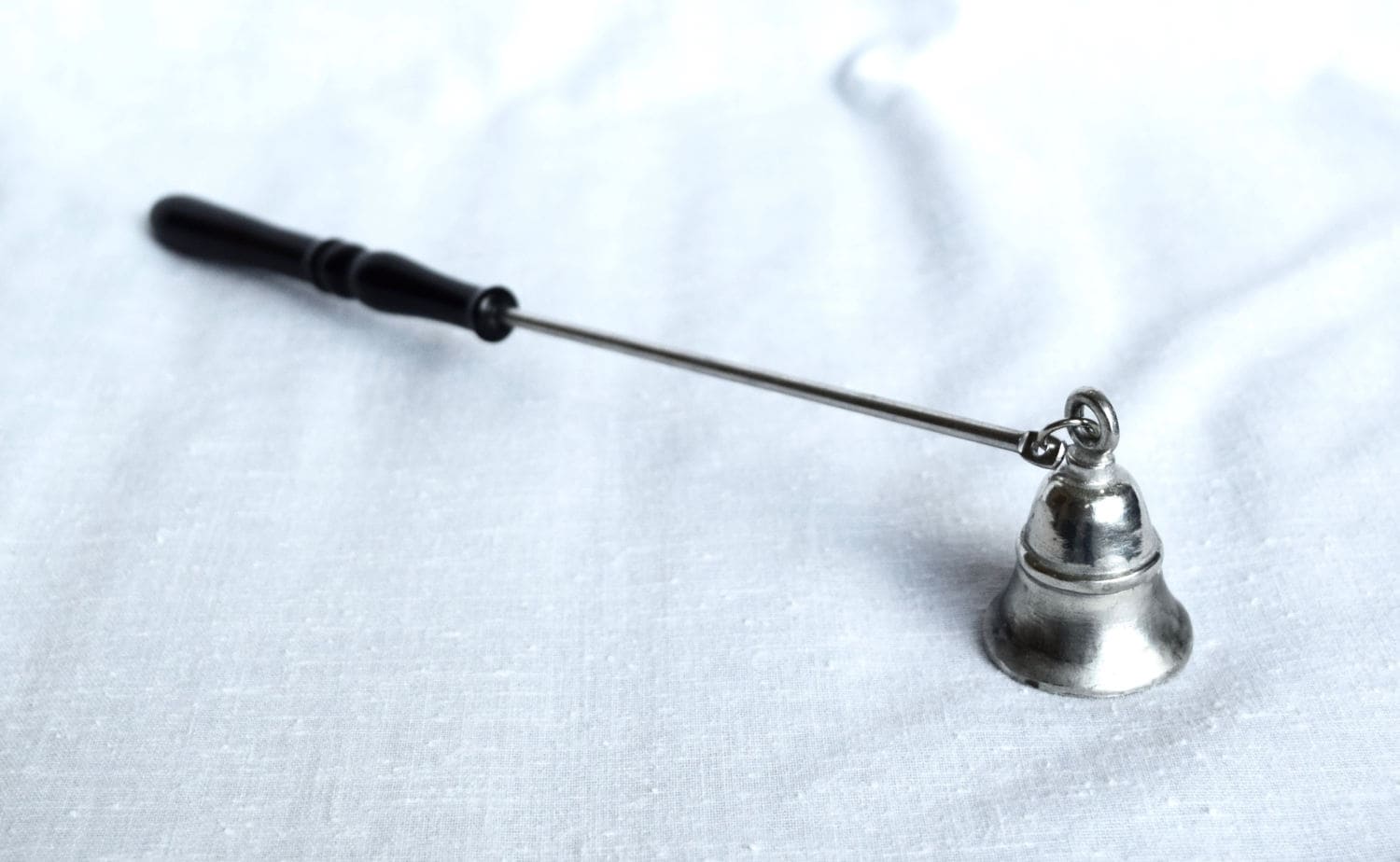 Vintage pewter candle snuffer with Bakelite handle.
