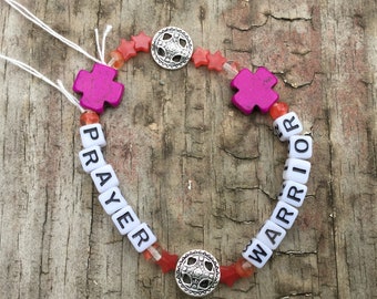 Prayer Warrior stretch bracelet with purple crosses and shields