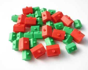 35 vintage Monopoly game pieces, 22 plastic houses and 13 hotels, game tokens