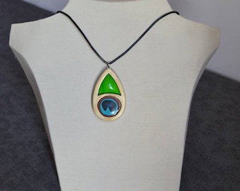 Pendant made in wood and accented with feather inspired polymer clay color Peacock