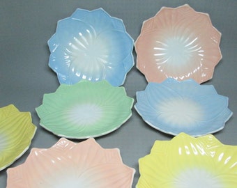 set of 7 milk glass plates Anchor Hocking Lotus pattern . 2 yellow , 2 blue , 1 green and 2 pink milk glass platonite