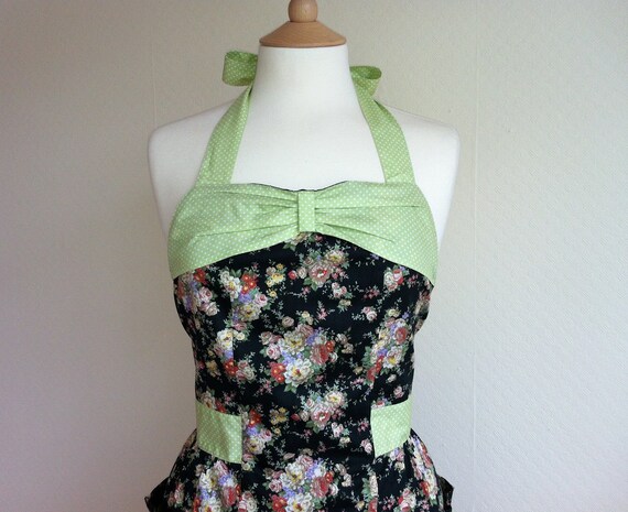 Retro apron with bow floral pattern on a black fabric. 1950s