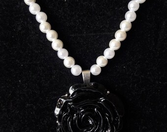 Her beauty is a dark rose necklace