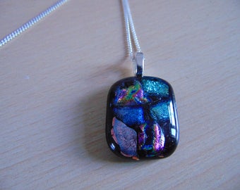 Mosaic pendant of fused dichroic glass rainbow on black