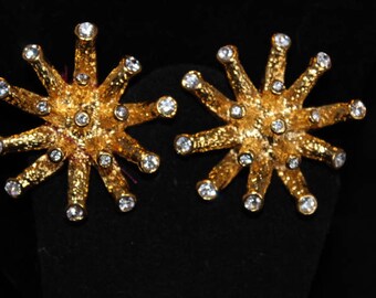 Goldtone starburst clip earrings with rhinestones