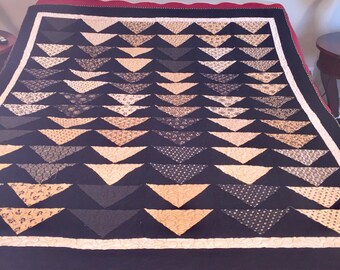 Black and Tan flying geese quilt. 59 by 68