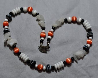 Coral and white catsye and black swirl beads