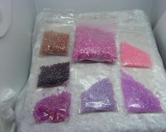 100 g of seed beads various shades of pink to purple