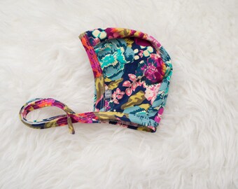 bold floral pilot hat by Little Lapsi. Baby hat with ties.