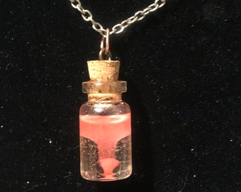Red Poe in a bottle necklace (Glows in the dark)