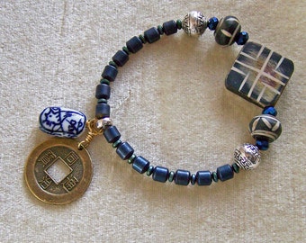 Blue hematite boho bracelet with a touch of the Orient.
