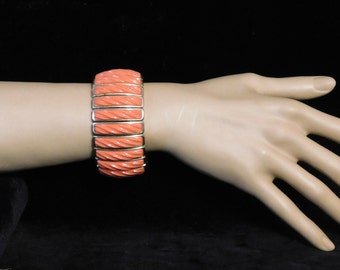 Cool orange 1960's bracelet-- thermoset plastic on expandable wristband