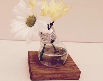 Quirky bulb vase with solid oak base.