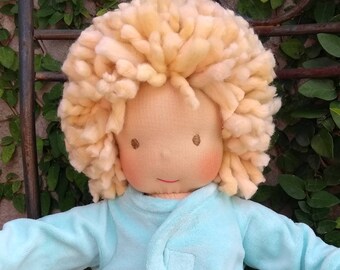 Baby inspired by the Waldorf pedagogy with pajamas and cloth diaper
