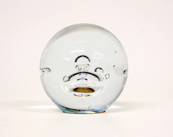 Glass paperweight with a drop of