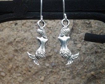 Silver Mermaid Earrings. Mermaid earrings hang from silver plated surgical steel earwires.