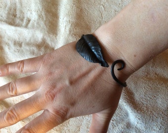 Hand forged metal bangle bracelet (adjustable). Leaf on left.
