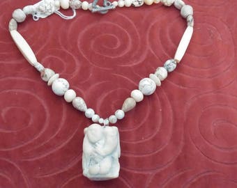 Carved aisian figure necklace