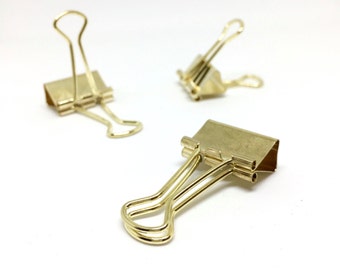 Gold coloured solid bulldog paper clips
