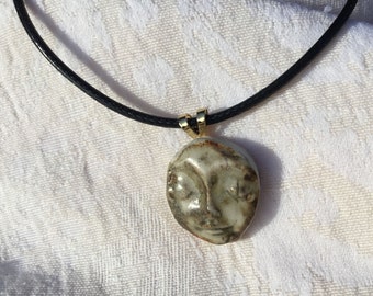 Moon pendant, female face resting