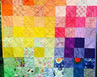 Lap-sized patchwork quilt in rainbow colors, baby rainbow blanket