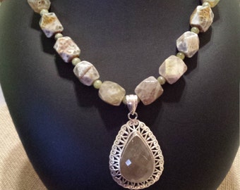 One strand beaded faceted necklace with sterling pendant