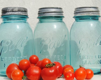 Three blue Ball Mason jars with zinc lids