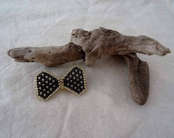 Black and gold bow brooch