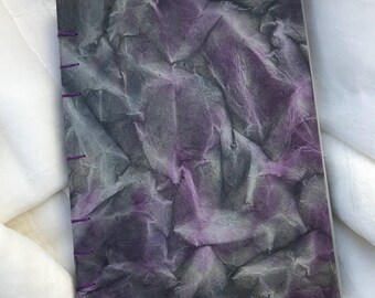 Purple and black coptic stitch journal