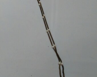 Altered Metal and Plastic pearls Necklace with message in a glass pendant