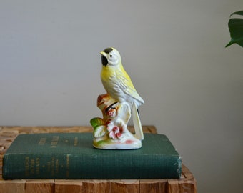 yellow ceramic bird figurine