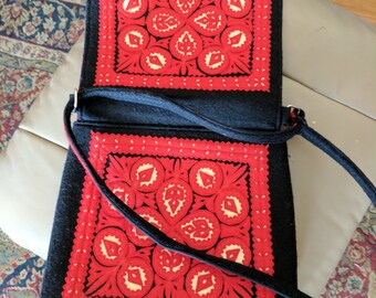 Vintage black, red, and cream colored applique felt purse.