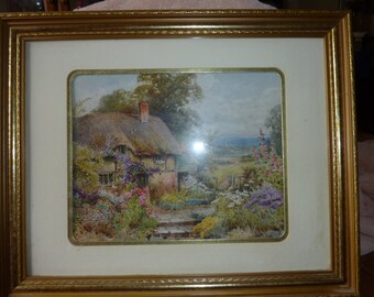 English Country Cottage with Thatched roof. Gorgeous flowers surround the home