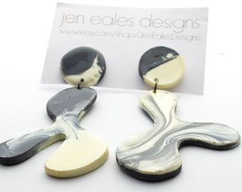 Contemporary handmade black and white lambda earrings
