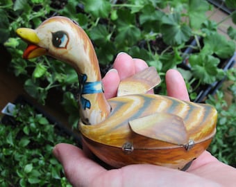 Antique 1950's tin duck toy with wheels