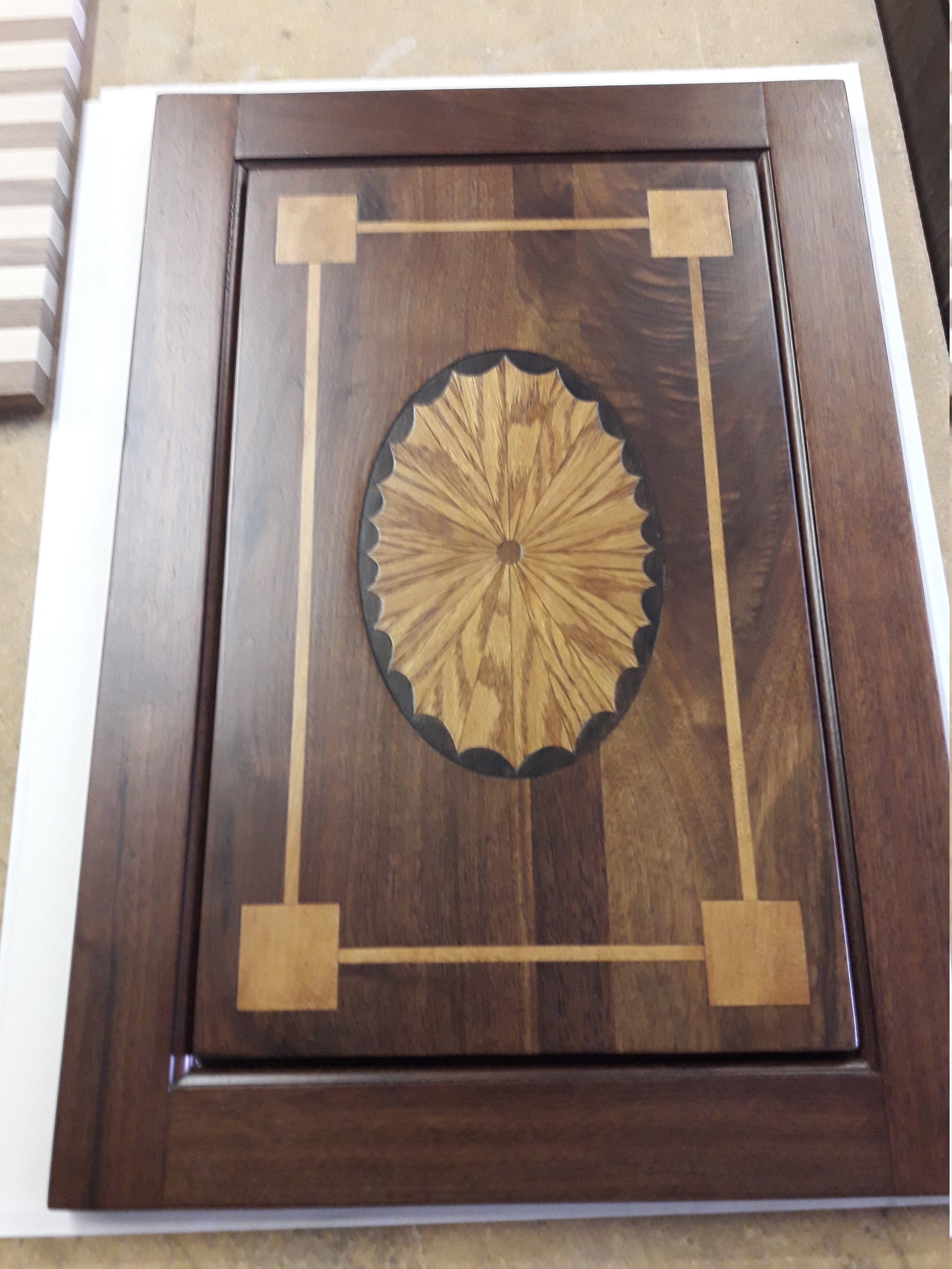 walnut console door with sunburst inlay