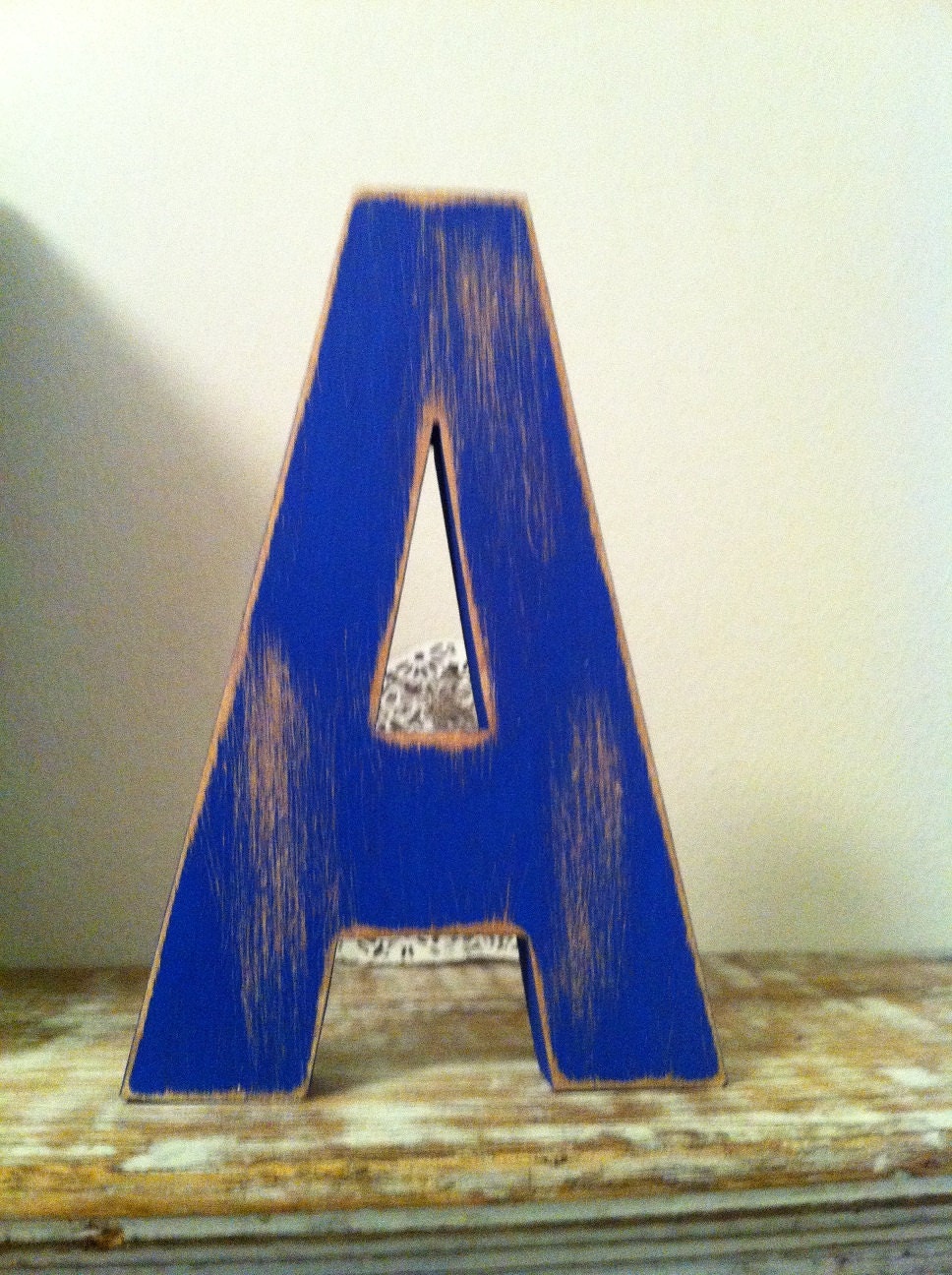 Letter A in Ariel font, painted in Union Jack blue, with heavy distressing