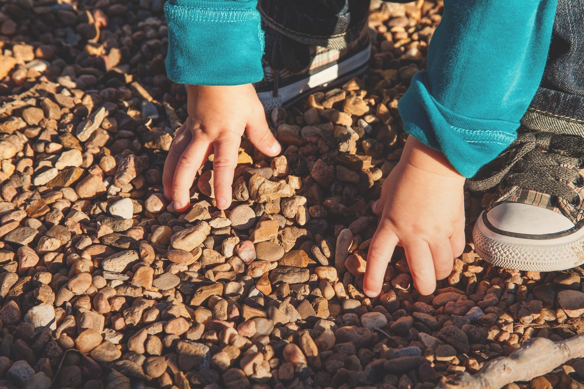 Outdoor play, pebbles, child, explore, sensory