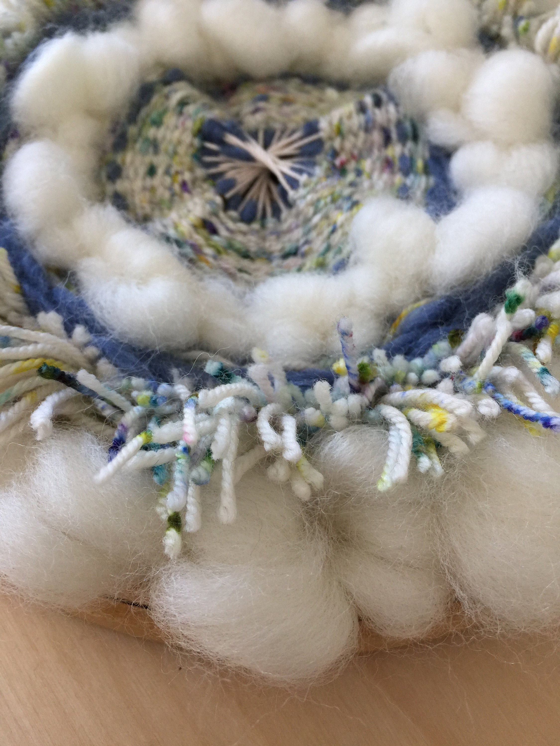 Circular Wall Hanging made with wool roving and indie dyed wool.