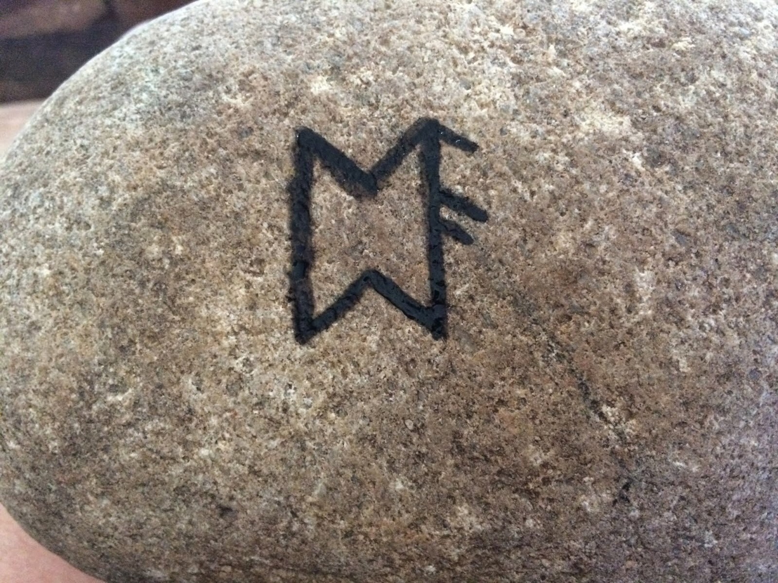 Bindrune painted on the back of the garden stone