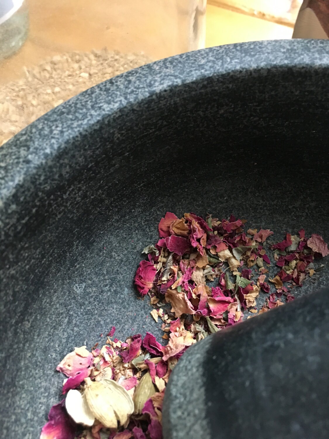 Add rose petals and ginger root and gentle use your mortar and pestle to open and blend