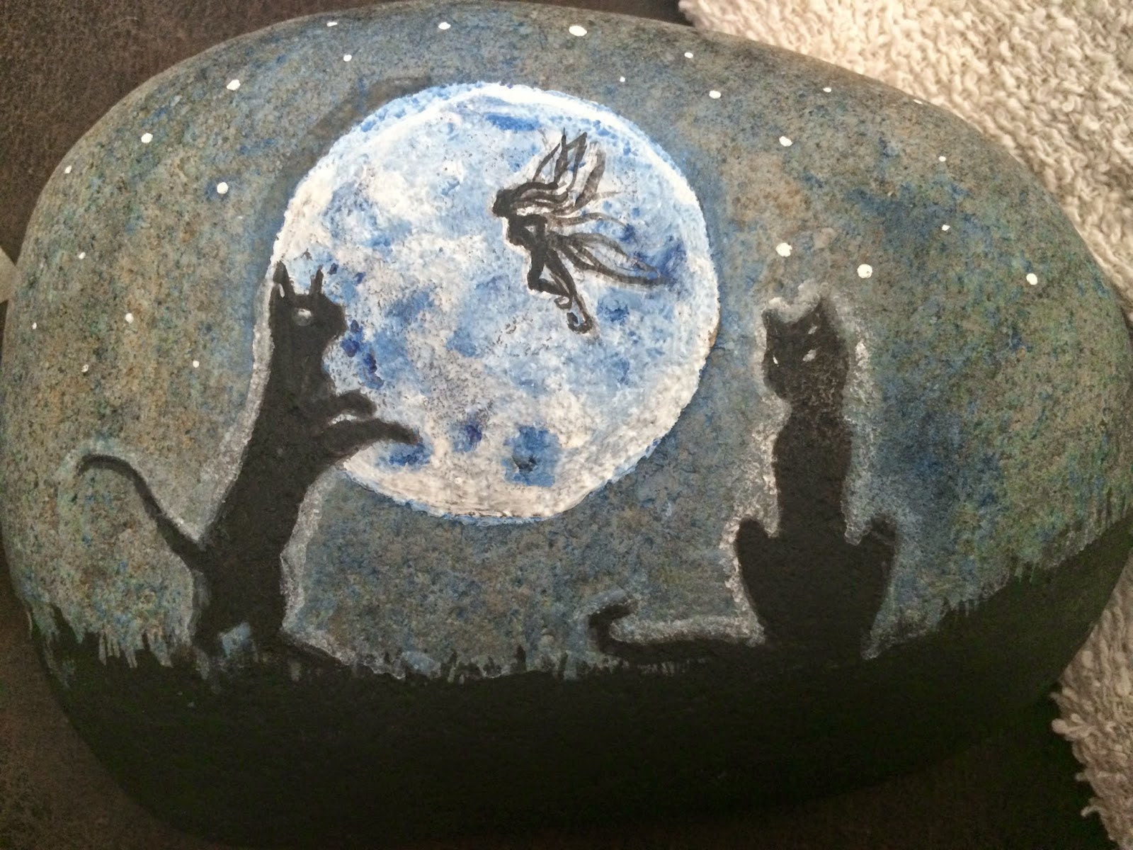 Fairy silhouette added above the cats with glowing eyes