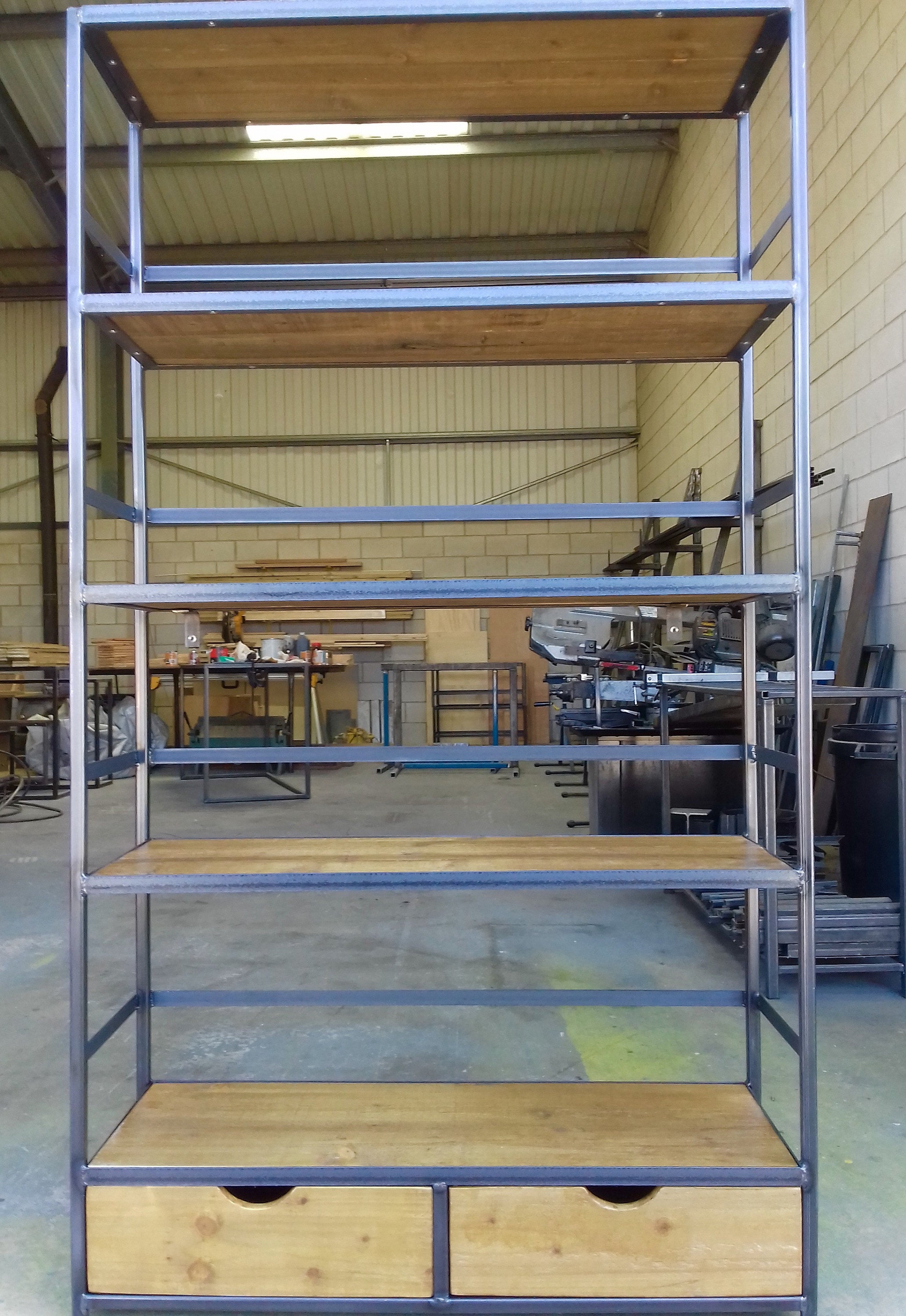 Custom made shelving unit based on the retaining bar design, larger in width and height with two drawers.