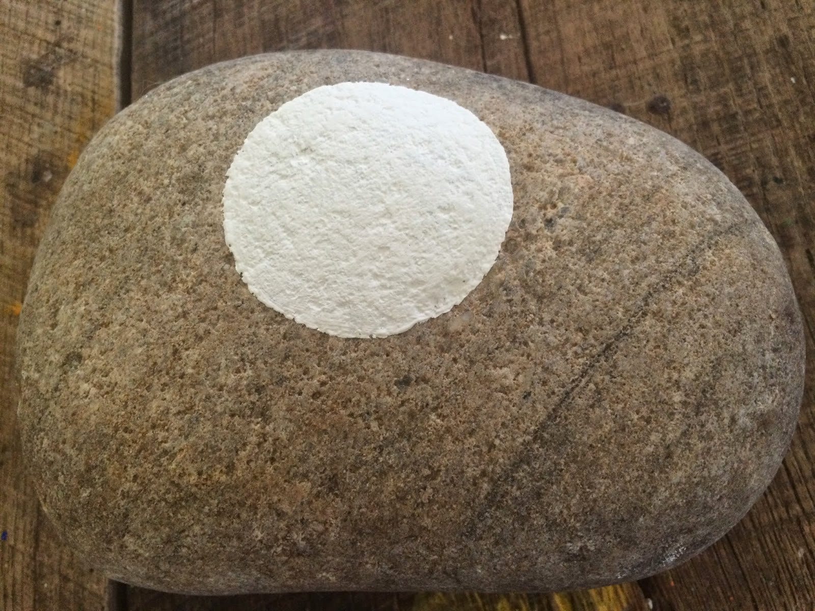 White circle painted on the stone for the moon