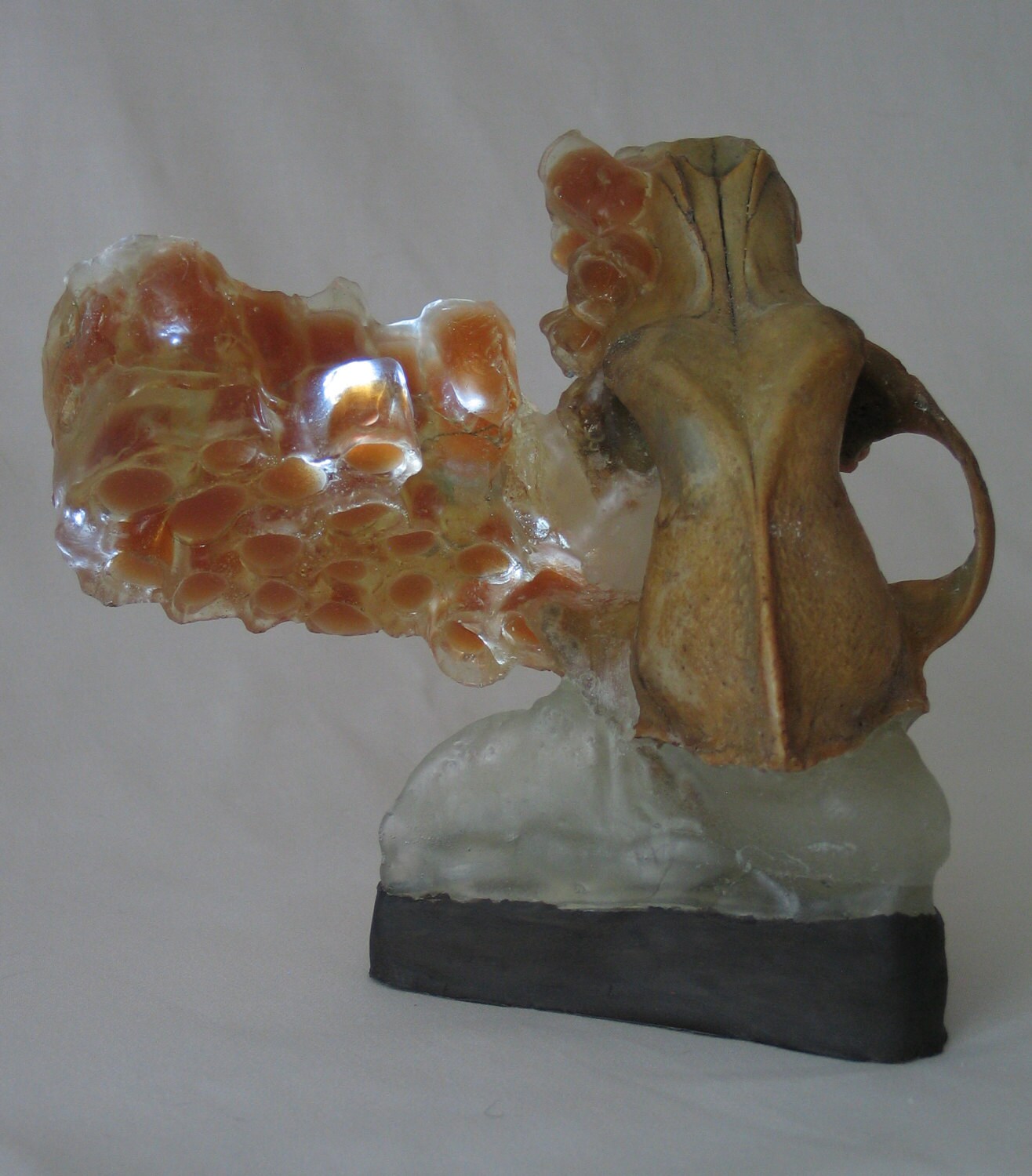 Translucent amber honeycomb with embedded LEDs built around a dog skull. Apis habilis: Honeycomb Number 12
