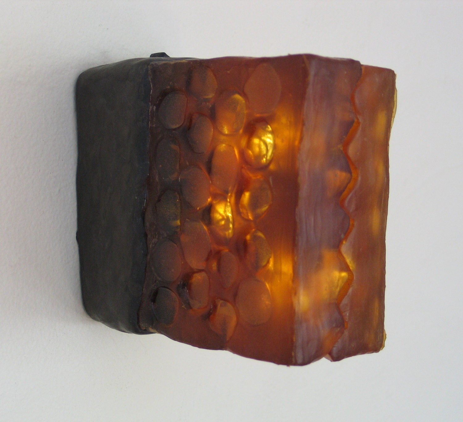 Translucent amber honeycomb with embedded LEDs .  Apis habilis:  Honeycomb Number 8